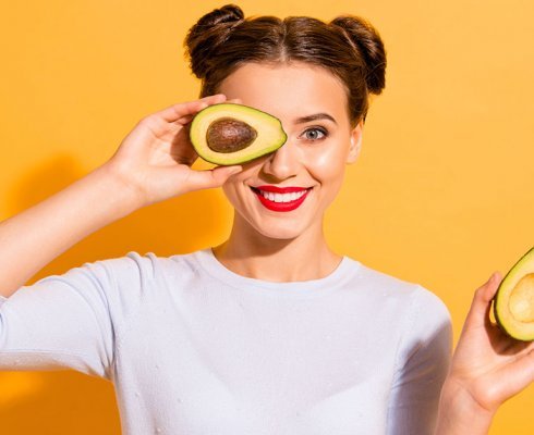 Close up photo beautiful she her lady pretty hairdo hold slices avocado hide eye used amazing salon mask oil extract procedure wearing casual white pullover clothes isolated yellow background; blog: 6 Digestive Superfoods and their Benefits