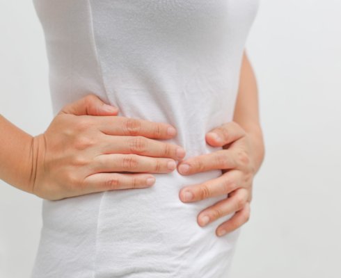 A woman suffering from gastrointestinal issues