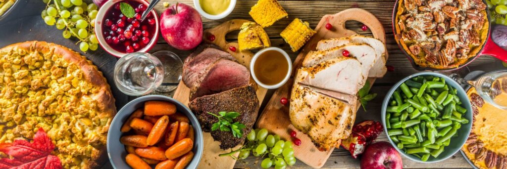 a spread of holiday foods on a table to illustrate The Best and Worst Holiday Foods for Digestion